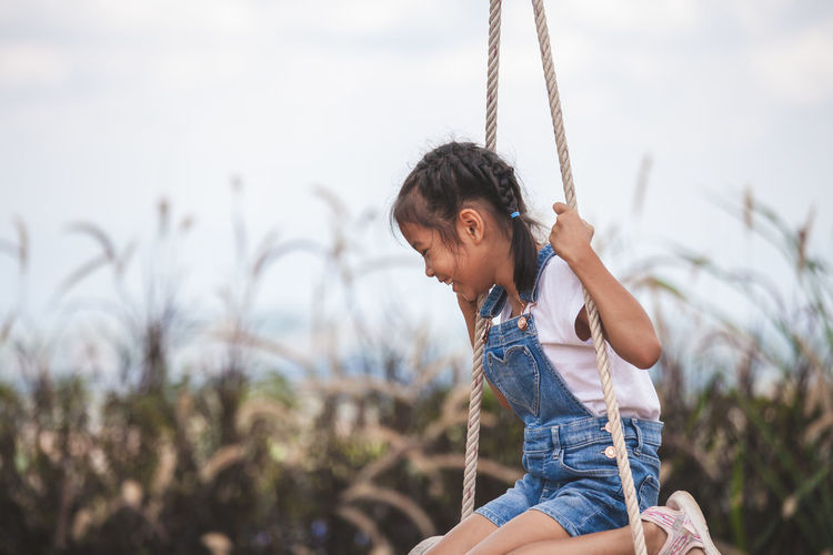 Girl swinging at playground