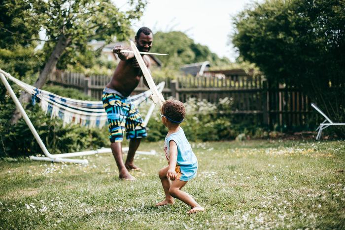 Father and son playing in yard