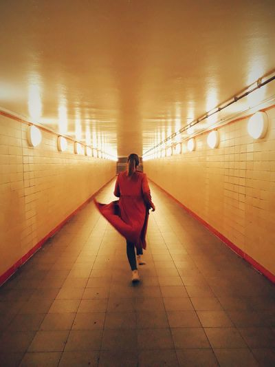 Rear view of woman walking in subway