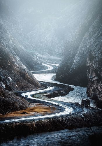 Snow covered road by river