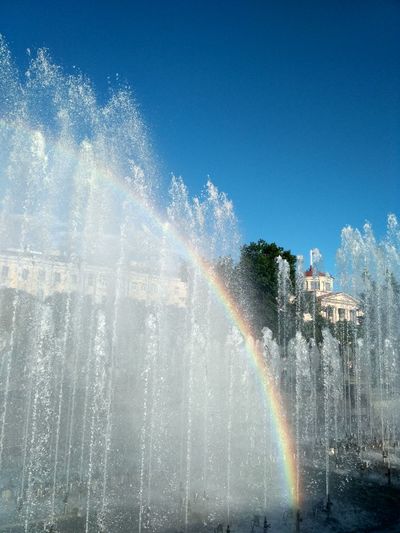 Rainbow over water against sky