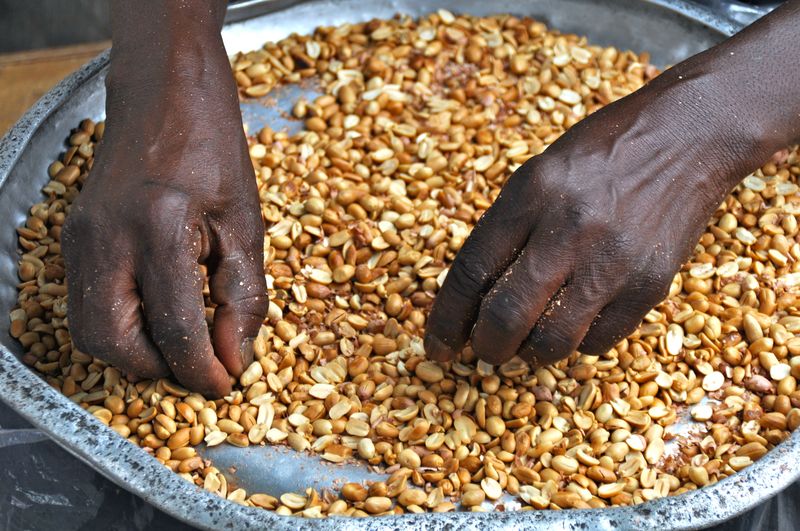 Cropped hands cleaning nuts in container