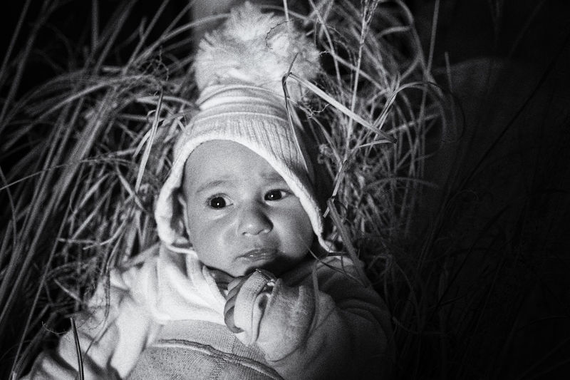 Cute baby girl on grass at night