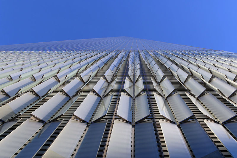 Low angle view of one world trade center against clear blue sky