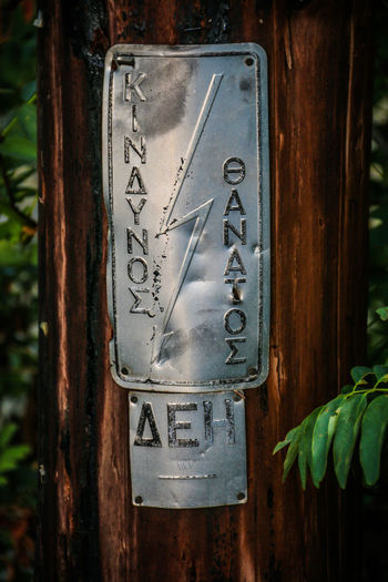 Close-up of information sign on wood