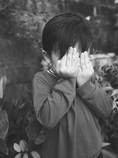 Close-up of child covering his face