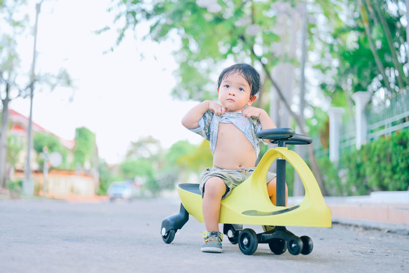 Portrait of cute boy riding motorcycle