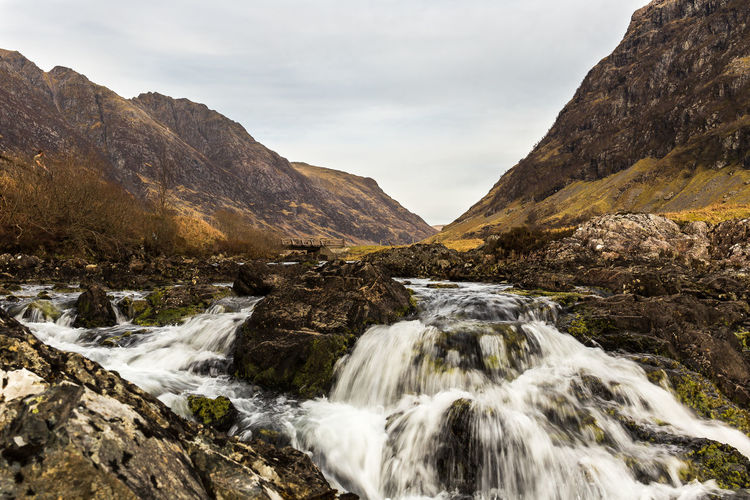 Scenic view of waterfall against sky