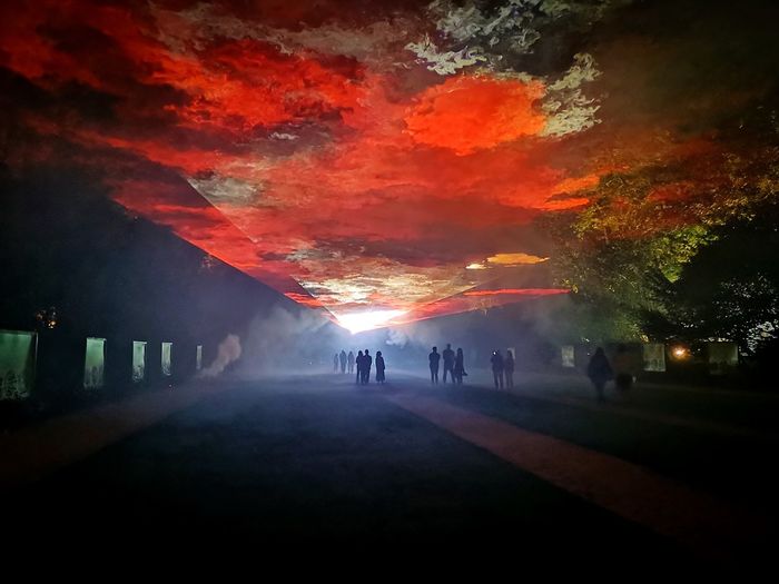 People walking on footpath during sunset