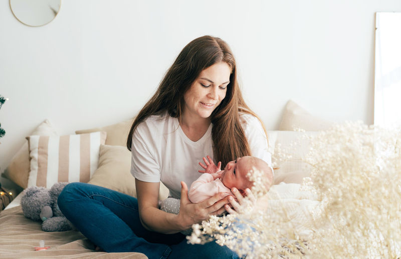 Mother with daughter sitting at home