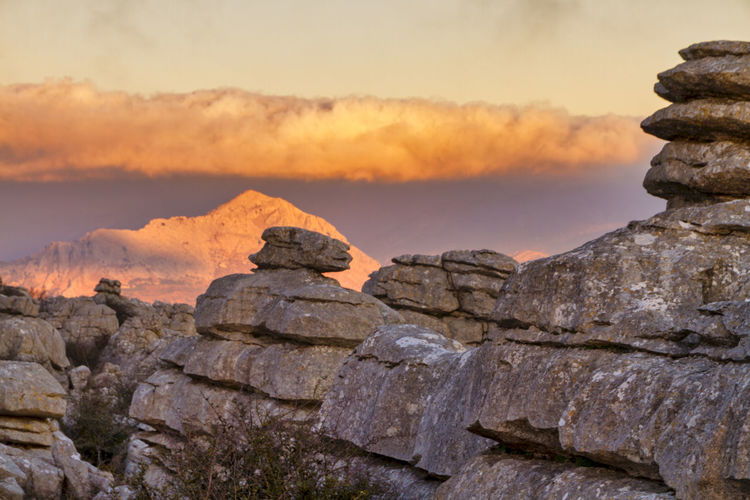 Stack of rocks against sky during sunset
