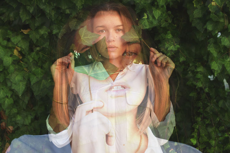 Multiple exposure of young woman standing against plants at park