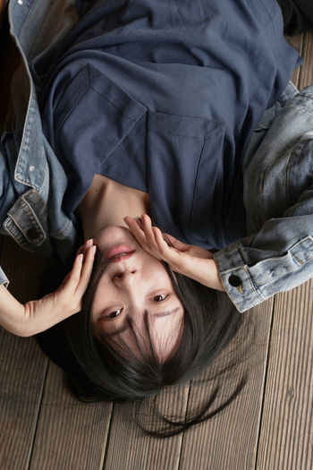 Portrait of young woman lying on floor