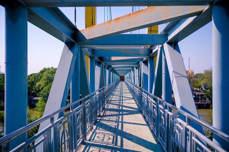 Low angle view of footbridge against sky