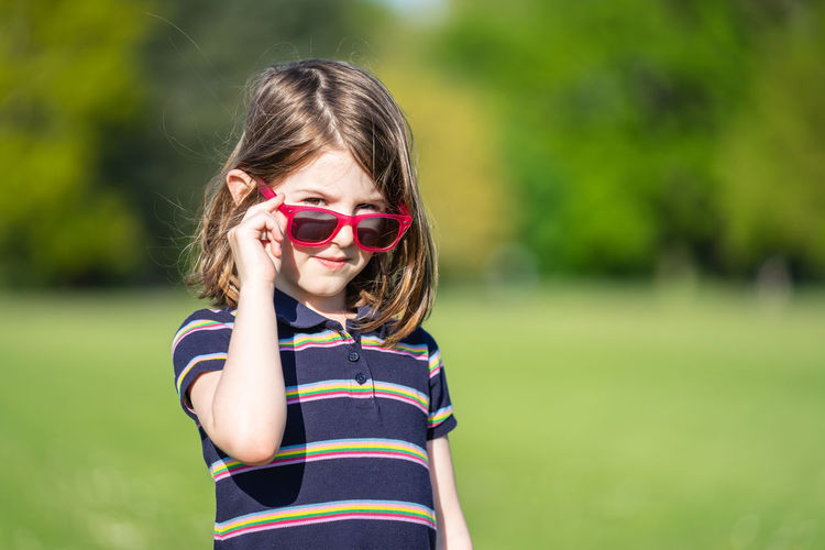 Portrait of girl wearing sunglasses standing outdoors