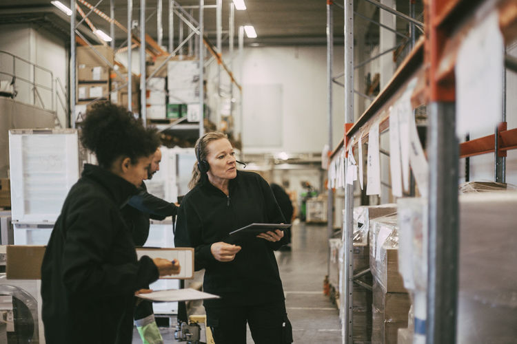 Female coworkers taking inventory at warehouse