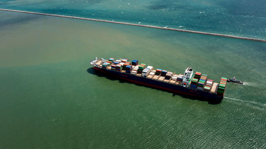 Container ship export and import business services and logistics. shipping cargo to harbor transport