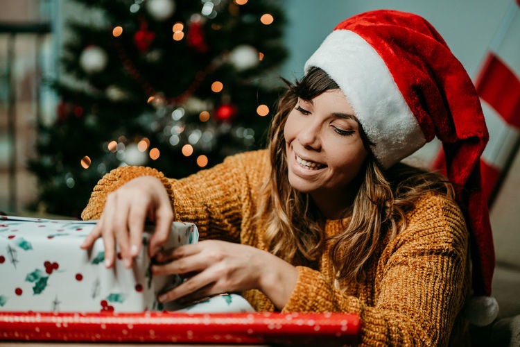 Smiling young woman with christmas tree