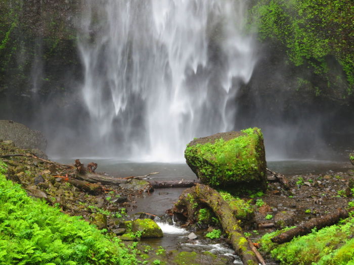 Scenic view of waterfall against sky