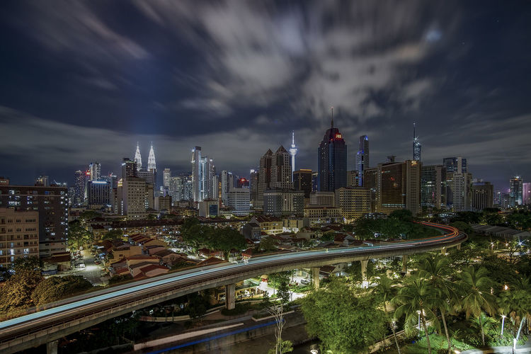 High angle view of illuminated cityscape against sky at night