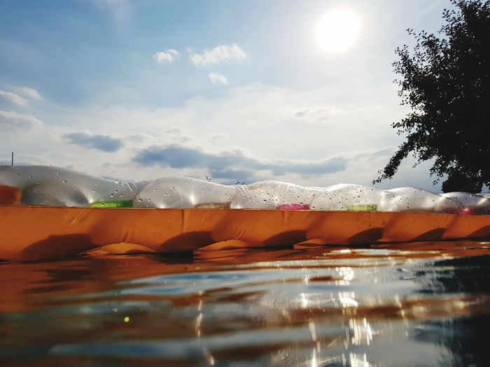 Surface level of water against orange sky