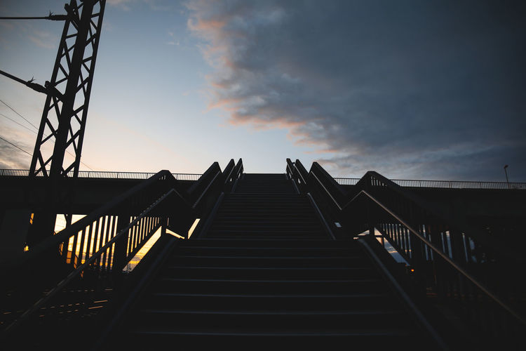 Low angle view of staircase against sky during sunset