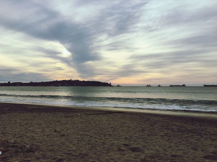 Scenic view of beach against sky during sunset