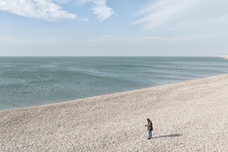 Person standing on sand at beach