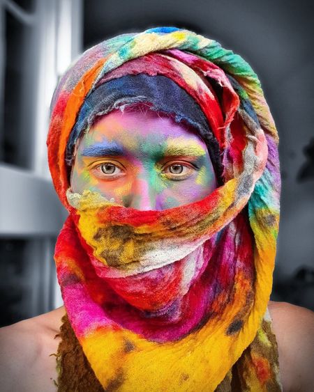 Portrait of man with multi colored face