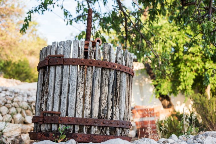 An old wooden grape press used for wine production in the mediterranean countries. wooden boards