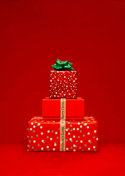 Close-up of christmas presents against yellow background