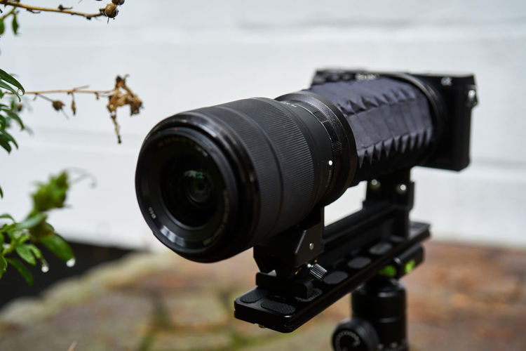 Digital camera with bellows and zoom lens on a tripod, macro photography arrangement