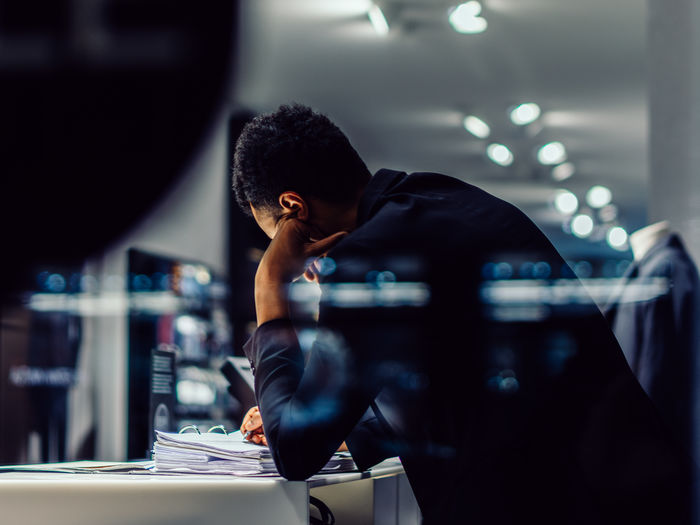 Shopkeeper of a fashion store checking the books Adult Adults Only Bookkeeping Business Dedication Desk Fashion Store Illuminated Indoors Leaning Looking Down Men Night One Man Only Only Men Real People Reflection Relaxed Sales Store Street Photography Streetphotography Working