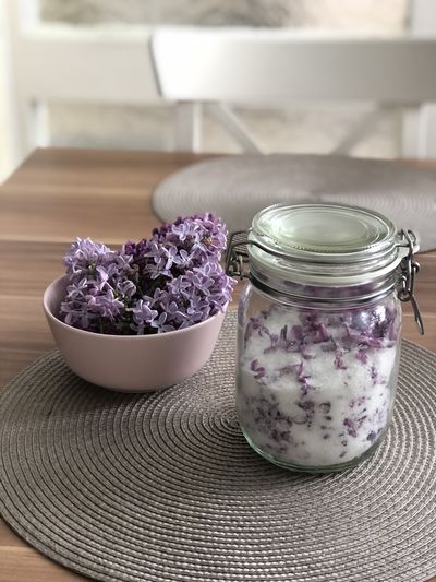 Close-up of purple flowers in jar on table