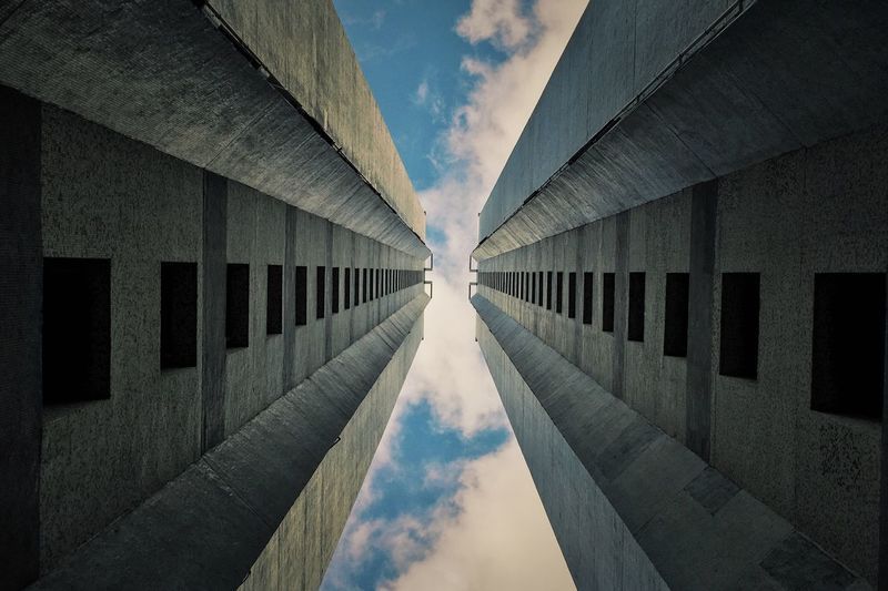 Directly below shot of buildings against sky