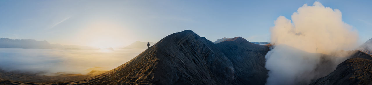 Panoramic view of man standing on mountain