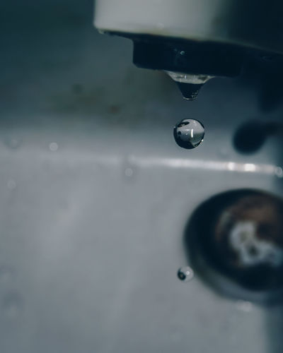 Close-up of water drop from faucet
