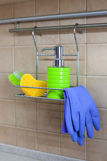 Close-up of gloves and sponge on rack