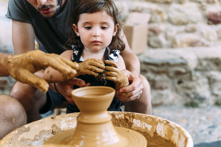 Father and daughter in a pottery workshop