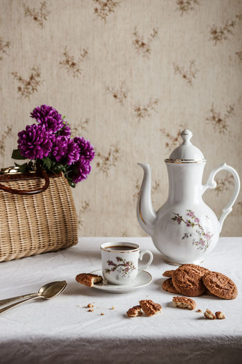 Coffee served on classic tableware with cookies in a vintage home