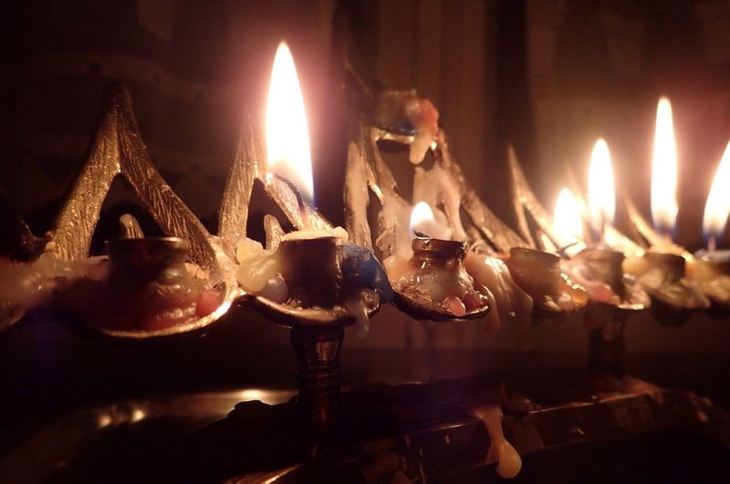 Close-up of hanukkah candles burning on menorah