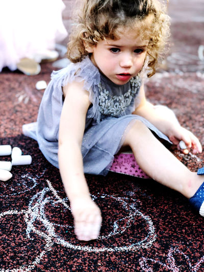 Cute baby girl sitting on carpet
