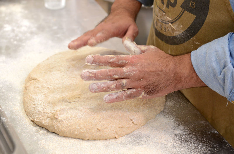 High angle view of man preparing dough