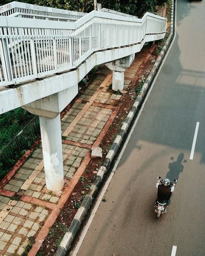 High angle view of man riding motor scooter on street
