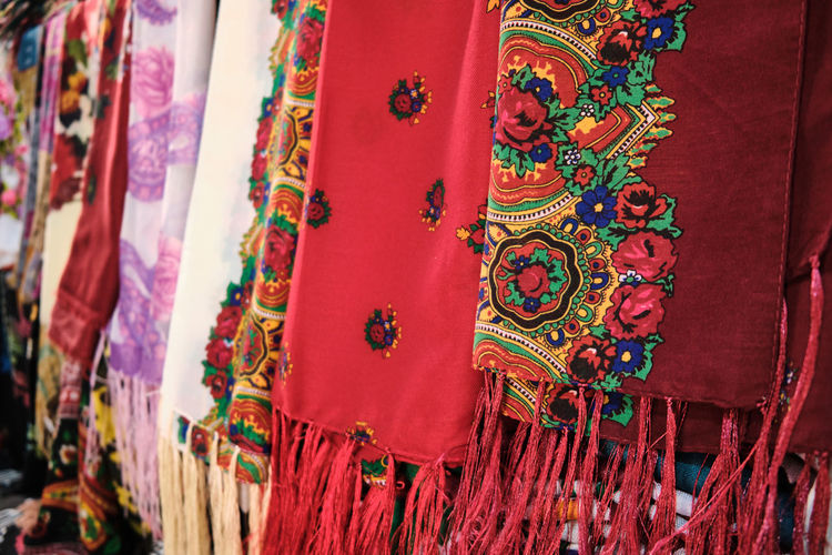 Colorful traditional middle eastern shawls hanging at bazaar. multi-colored headscarfs
