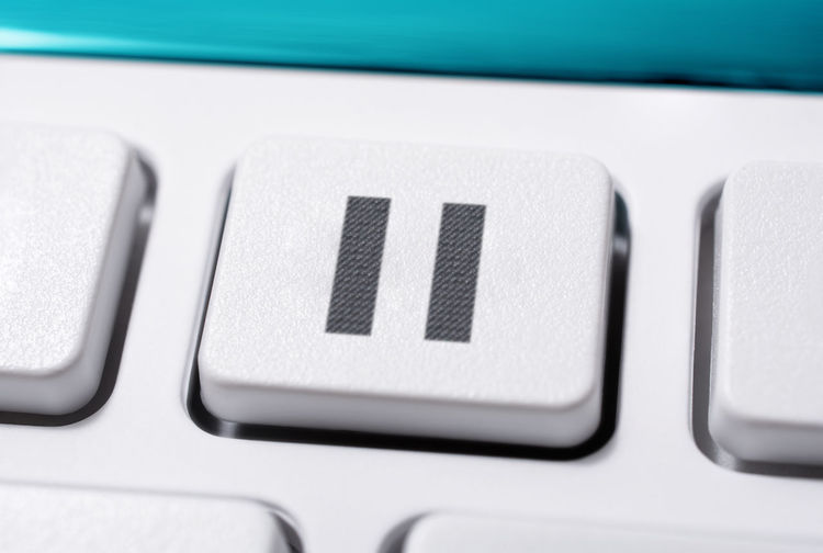 Close-up pause icon on button of computer keyboard