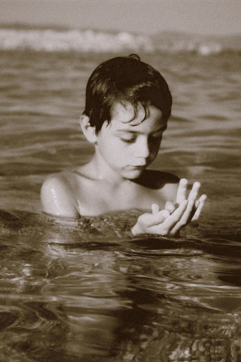 Portrait of shirtless boy in swimming pool
