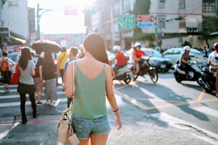 Rear view of woman walking on street