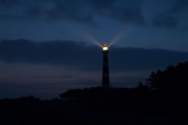 Low angle view of silhouette building against sky at night