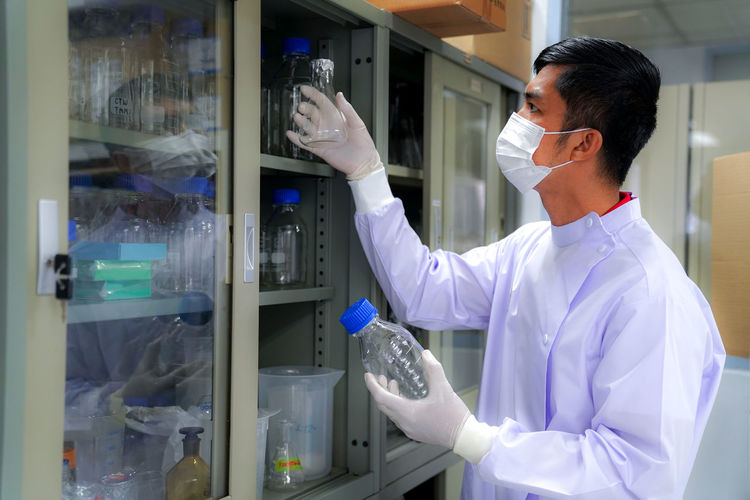 Side view of scientist working in laboratory